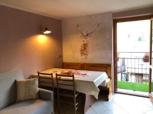 a dining room with a table with a deer head on the wall at Il GIGLIO in Ponte di Legno