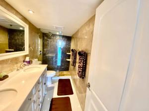a bathroom with a sink and a toilet and a shower at Look No Further!!! Amazing Condo in Fort Lauderdale +13 photos