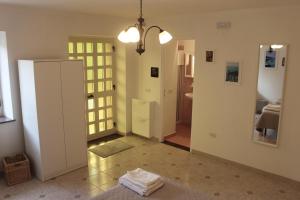 a living room with a refrigerator and a hallway at Clorofilla - Country House in Francavilla Angitola