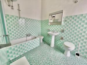 a bathroom with blue and white tiles and a toilet and sink at Casa di Nonna in Montefranco +28 photos