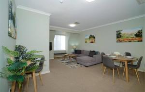 a living room with a couch and a table at 40 Modern & Chic Apt In East Perth in Perth