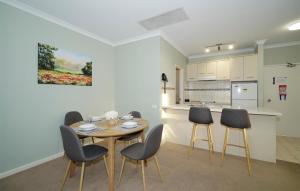 a kitchen and dining room with a table and chairs at 40 Modern & Chic Apt In East Perth in Perth