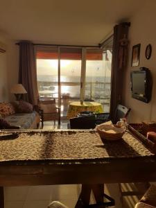 a living room with a view of the ocean at Amarras Reales in Piriápolis +6 photos