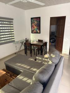 a living room with a couch and a table at Accra City Apartments 1 in Taifa
