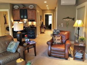 a living room with two leather chairs and a table at Riverfront condo with balcony, king bed STR#267 in Salida