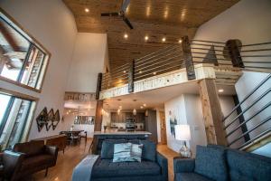 a living room with a couch and a staircase at Little Hope Chalet At Terry Peak Ski Resort in Lead
