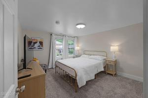 a bedroom with a bed and a window at Campbell Street Charm in Jackson