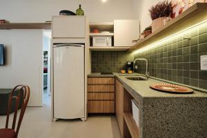 a kitchen with a refrigerator and a counter top at ESP508 - Apartamento Centro - Curitiba in Curitiba +11 photos