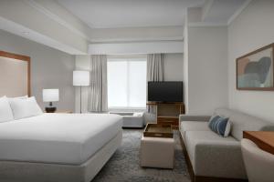 a hotel room with a bed and a couch at SpringHill Suites by Marriott Lynchburg Airport/University Area in Lynchburg +23 photos
