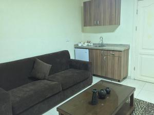 a living room with a couch and a coffee table at Zaina Plaza Hotel in Amman