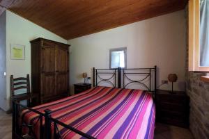 מיטה או מיטות בחדר ב-Agriturismo Mulino di Culmolle