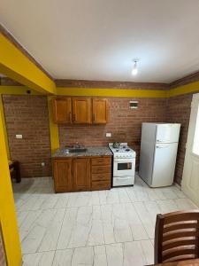 a kitchen with a white stove and a refrigerator at La bendicion in Villa Cura Brochero +13 photos