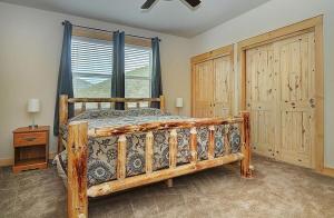 a bedroom with a wooden bed and a window at Salida - Monarch Family Getaway! in Monarch +30 photos