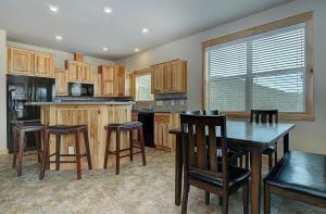a kitchen with wooden cabinets and a table and chairs at Salida - Monarch Family Getaway! in Monarch