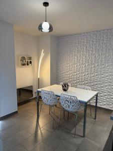 a dining room with a table and two chairs at Le Contemporain in Troyes +19 photos
