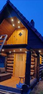 a large wooden cabin with a wooden deck at Tammiku Saunamaja & Bubble House in Röösa +74 photos