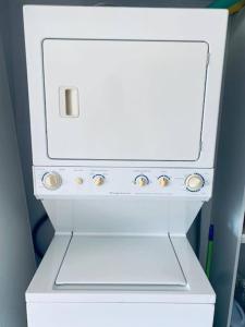 a white stove top oven sitting in a room at Stunning 9th Flr Pacific Ocean And Mtn View in Jacó