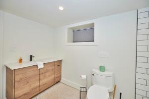 a bathroom with a toilet and a sink at Riverside Walk in Niagara Falls