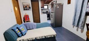 a living room with a couch and a refrigerator at Mi Rancho La Paloma in La Aguada