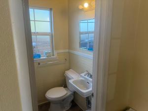 a bathroom with a toilet and a sink at Ranch Valley Express Inn in Laytonville