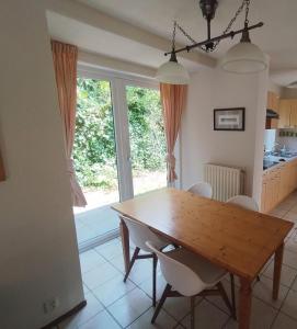 a dining room with a wooden table and chairs at Cozy Beach House Beautiful Water View, WiFi & Parking in Kamperland