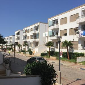 a car parked in front of a large apartment building at Puerto banus beach Apt Famillies and married couples in Mansouria