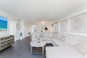 a living room with a white couch and a table at Prime Beach and Golf Retreat 2BR Pool & Balcony in Boca Raton