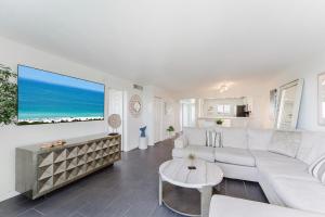 a living room with a white couch and a table at Prime Beach and Golf Retreat 2BR Pool & Balcony in Boca Raton