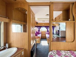 a bathroom with a sink and a van at Relax by the Sea Camping in Costinesti