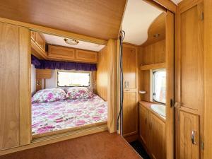 a small bedroom in an rv with a bed at Relax by the Sea Camping in Costinesti