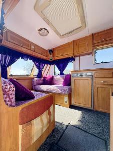 an interior view of an rv with purple furniture at Relax by the Sea Camping in Costinesti