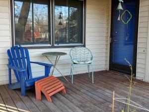 two chairs and a table on the porch of a house at Cozy Duke Park Retreat, Whole House in Durham