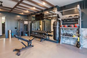 a gym with a punching bag and weights at Boulevard Stays Comfortable 1BR Suite w Pool Parking Gym 04 in Dallas