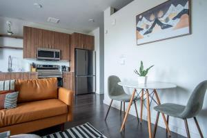 a living room with a couch and a table at Boulevard Stays Comfortable 1BR Suite w Pool Parking Gym 04 in Dallas