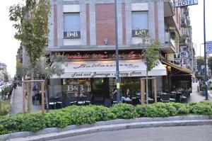 a restaurant with tables and chairs in front of a building at Baldassarre in Milan