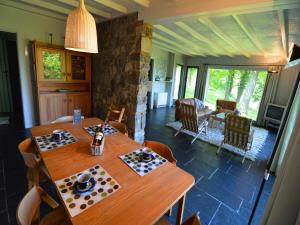 a dining room with a wooden table and chairs at Modern chalet with a view in Humain