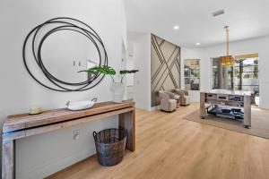 a living room with a large mirror on the wall at Tranquil Luxe Getaway in Palm Coast