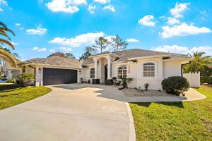 a white house with a driveway at Tranquil Luxe Getaway in Palm Coast