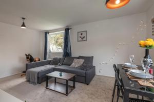a living room with a couch and a table at Luxus Flat Near Leeds City Centre in Central Station