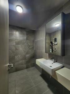 a bathroom with a sink and a mirror at Mossaz minimalist studio 3 in Petaling Jaya