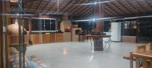 a large room with a kitchen with a table and chairs at Sítio Vista Alegre in São Luiz do Paraitinga +15 photos