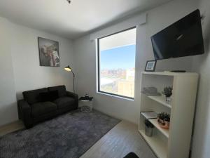 a living room with a couch and a window at 806 Deluxe Delight Concert Hall Studio in Perth +30 photos