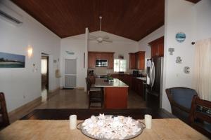 a kitchen and living room with a table and a kitchen at Oceanfront Resort-Style Oasis -Private Pool & Car in Grand Turk