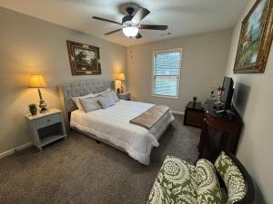 a bedroom with a bed and a ceiling fan at Unwind in Winder in Winder