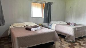 Katil atau katil-katil dalam bilik di Casa Raizes Pousada