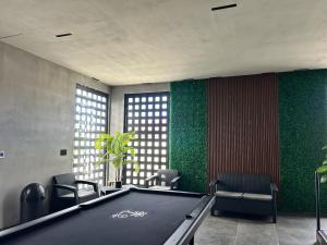 a pool table in a room with green walls at Habitación 4 in Rosarito Beach
