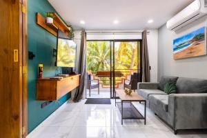 a living room with a couch and a table at nNomad Studio mins from Sirena - Apartment in Sosua