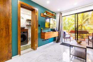 a kitchen with blue walls and a dining room at nNomad Studio mins from Sirena - Apartment in Sosua