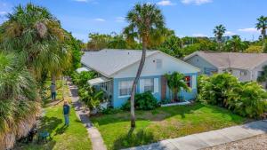 a family standing in front of a blue house at Treasure home in St-Pete Beach in St. Pete Beach