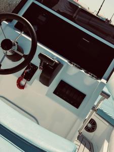 a dashboard of a boat with a steering wheel at Wave Dancer in Hurghada +3 photos